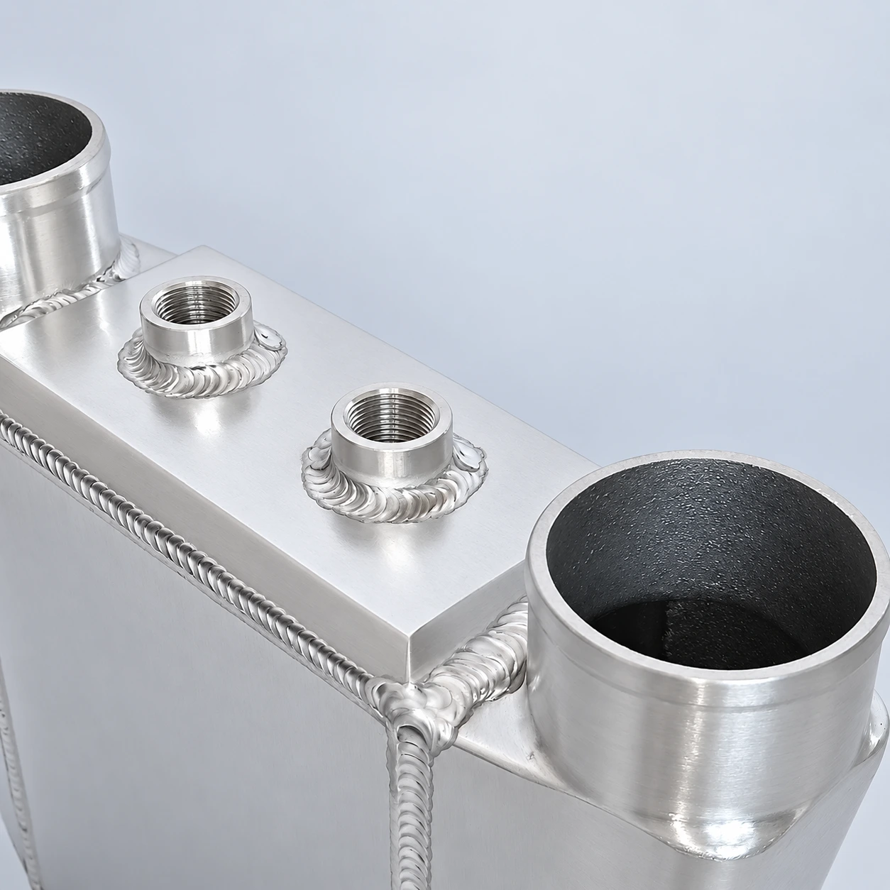 close-up · Threaded coolant connections and welds