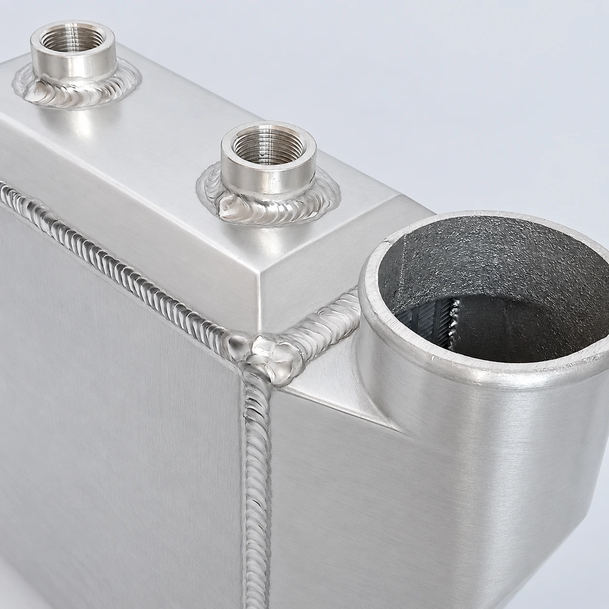 AWIC006-A close-up · Threaded coolant connections and welds