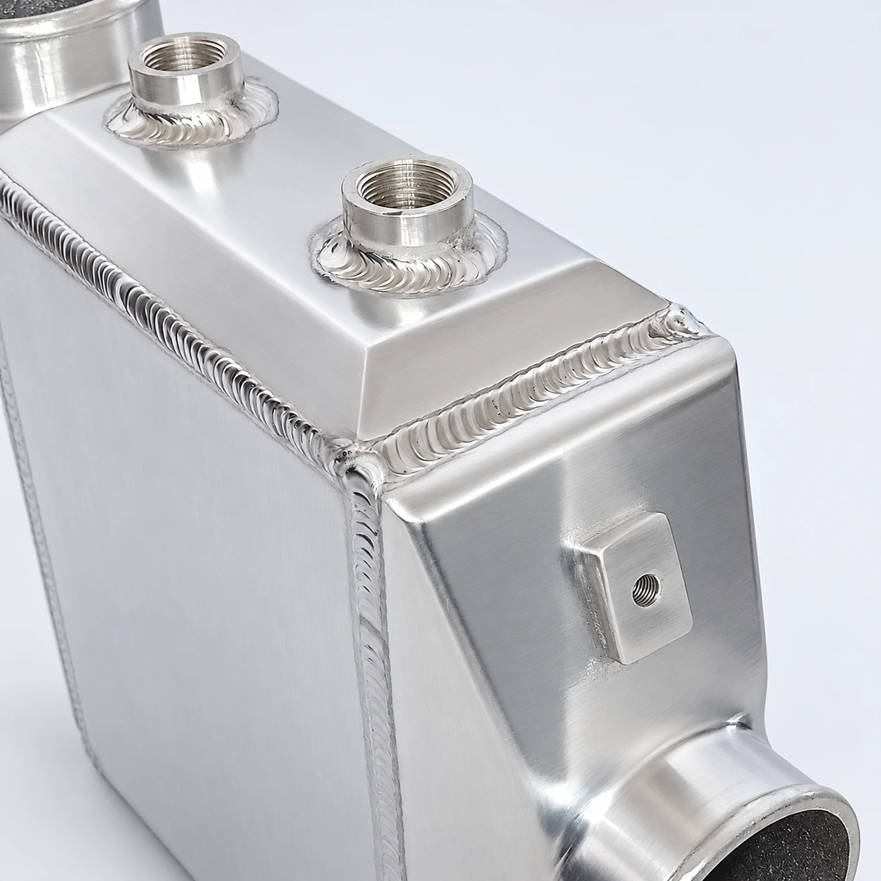 close-up · Threaded coolant connections and welds