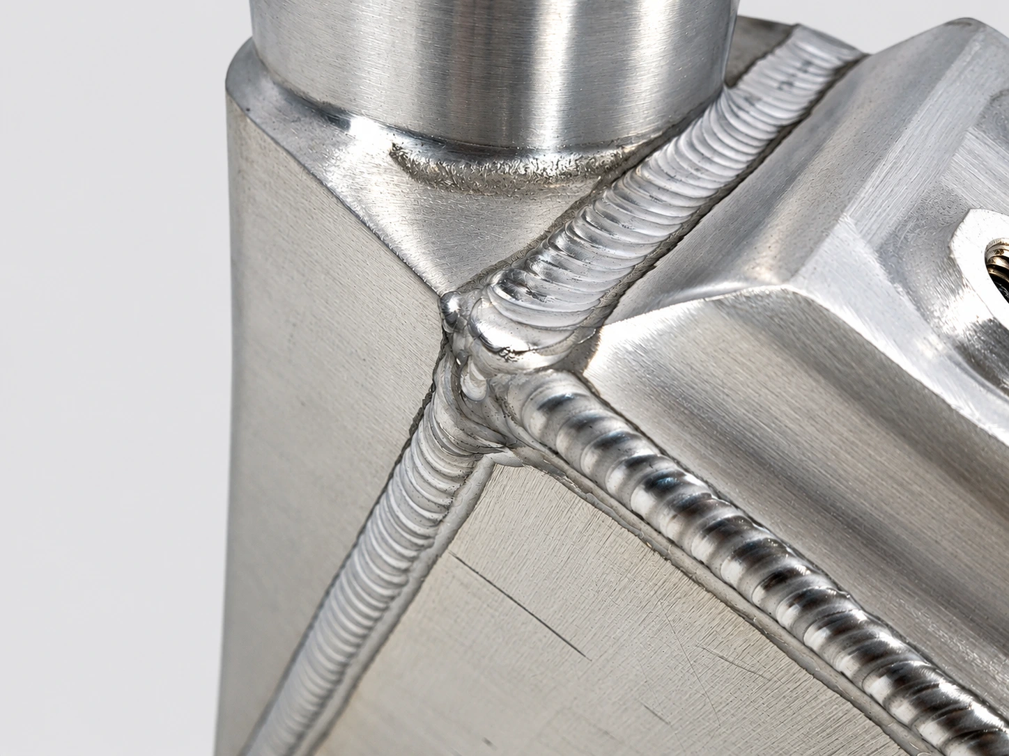 Close-up of the SEA-DOO GEN-3 Power Cooler aluminum weld beads at the housing and connection joint